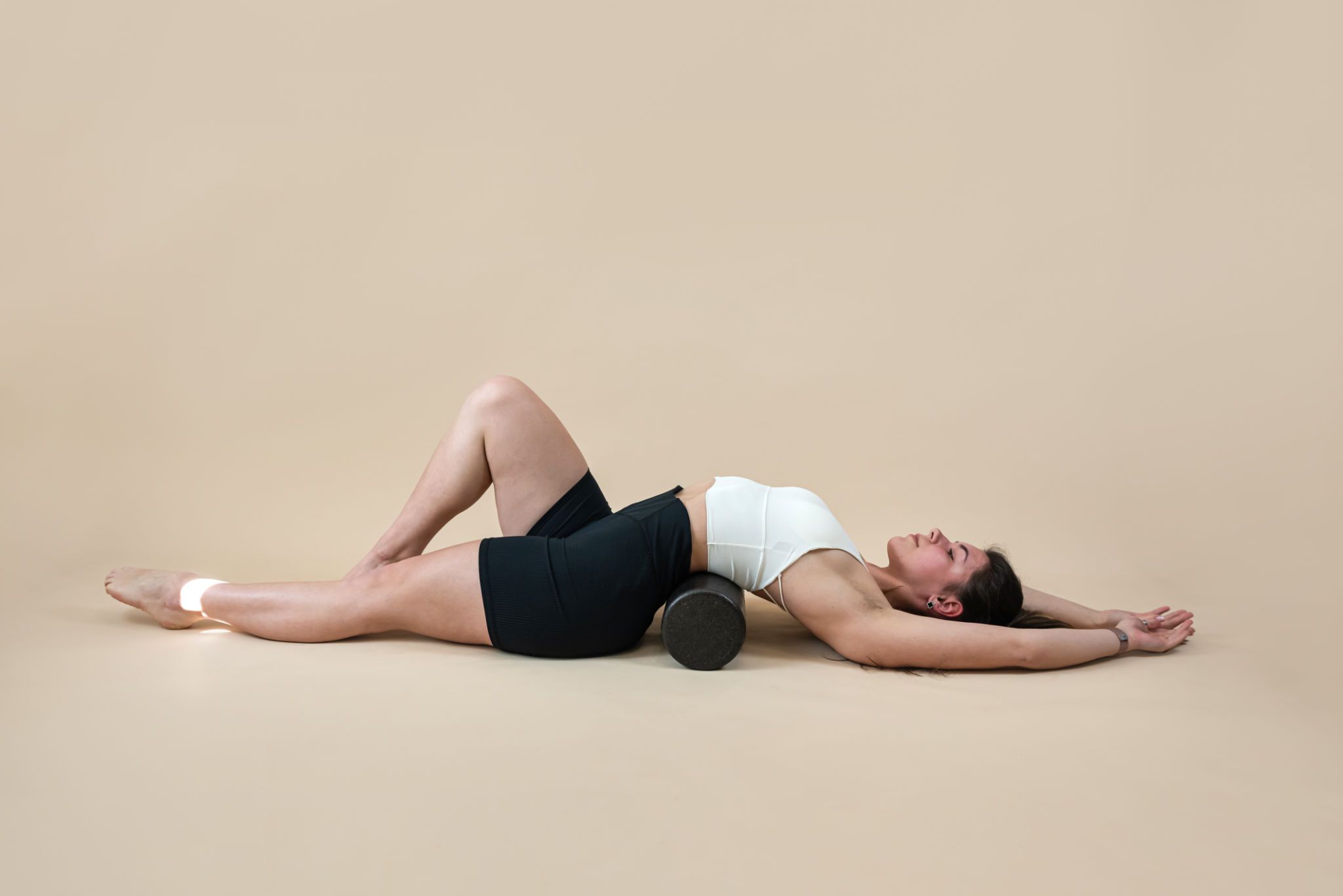 sporty woman doing fascia exercise with foam massage roller isolated sporty woman doing fascia exercise with foam massage roller isolated