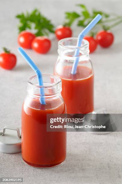 two bottles of tomato juice with straws - tomato juice stock pictures, royalty-free photos & images
