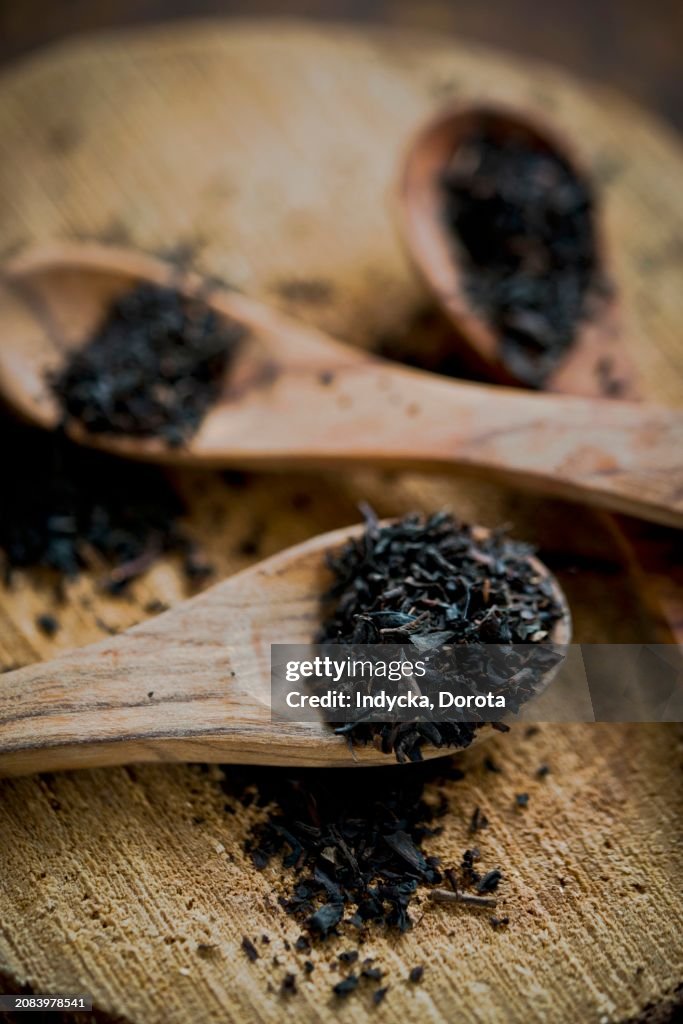 Earl Grey tea leaves on wooden spoons