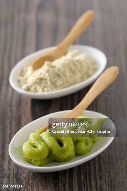 wasabi with wooden spoons in small bowls - wasabi paste stock pictures, royalty-free photos & images