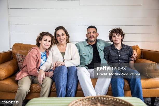 portrait of family on couch - mature man smiling 40 44 years blond hair stock pictures, royalty-free photos & images