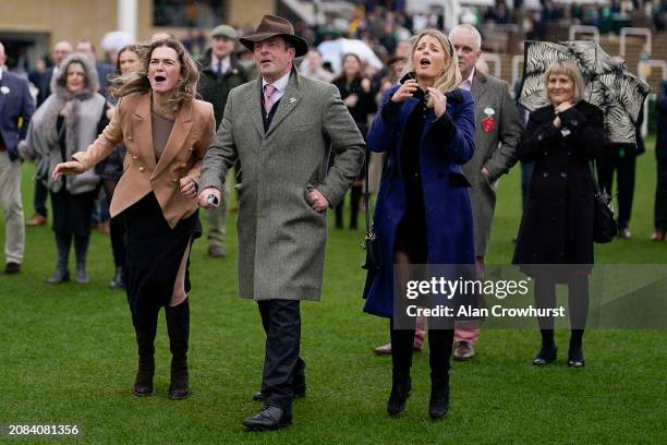 Emotions run high as connections watch the big screen as the race nears its finish during day three of the Cheltenham Festival 2024 at Cheltenham...