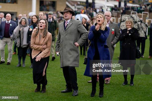 Emotions run high as connections watch the big screen as the race nears its finish during day three of the Cheltenham Festival 2024 at Cheltenham...