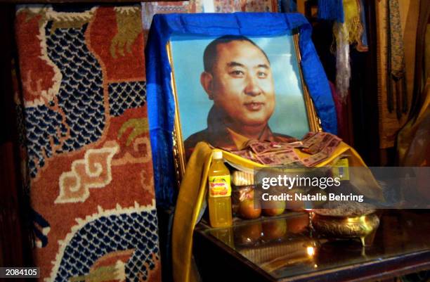 Portrait of the Panchen Lama is offered fruit and juice on June 16, 2003 at the Wudangzhao monastery in Inner Mongolia, China. Since photographs of...