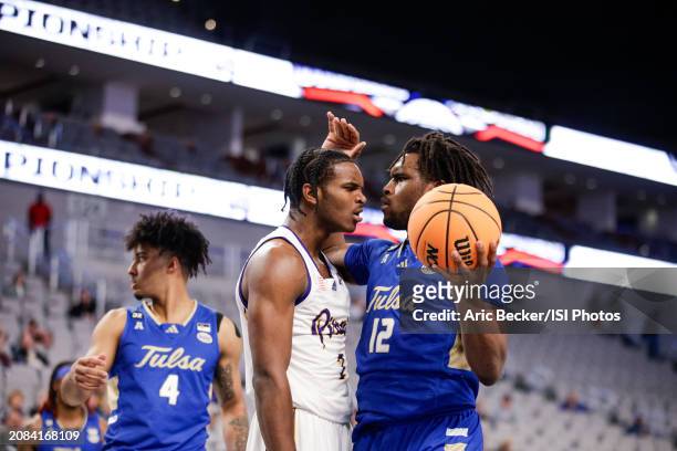 Ezra Ausar of the East Carolina Pirates looks at Carlous Williams of the Tulsa Golden Hurricane after a made basket during the AAC Men's Basketball...