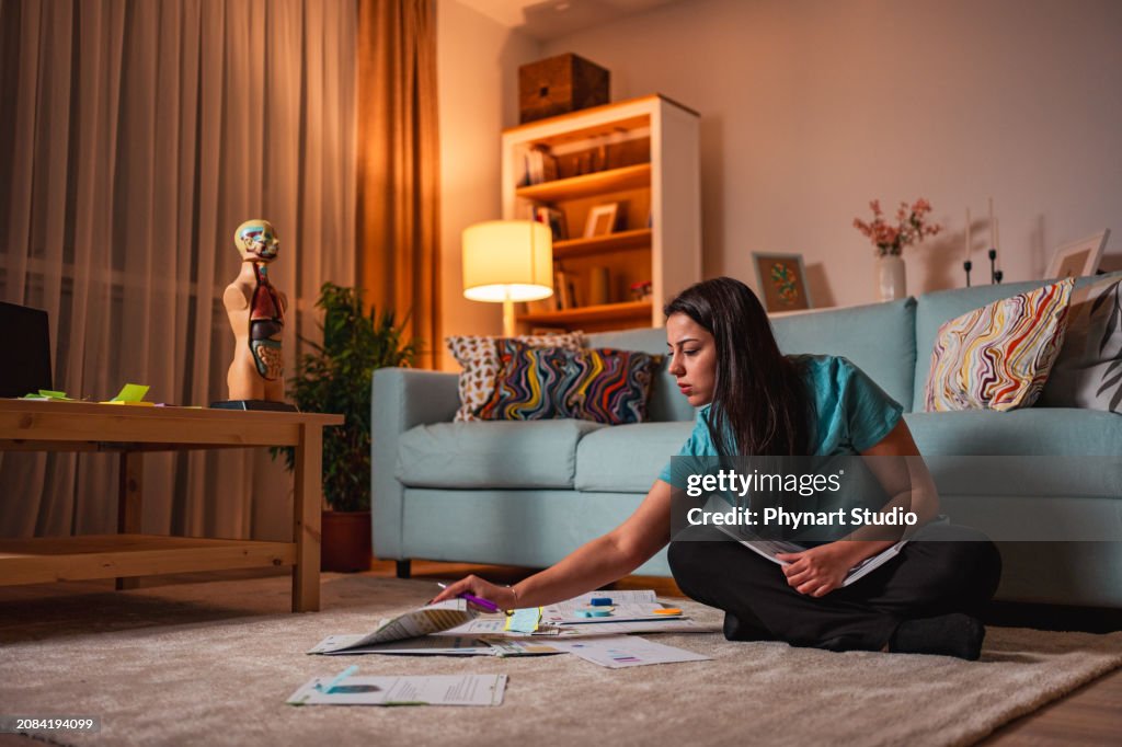 Young women working late at home using laptop