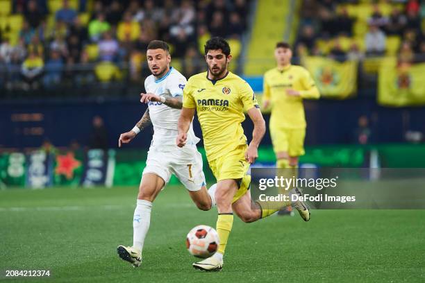 Gonzalo Guedes of Villarreal CF and Jonathan Clauss of Olympique Marseille battle for the ball during the UEFA Europa League 2023/24 round of 16...