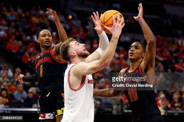 Tyler Wahl of the Wisconsin Badgers goes up for a shot against Jahmir Young and Julian Reese of the Maryland Terrapins in the first half in the...