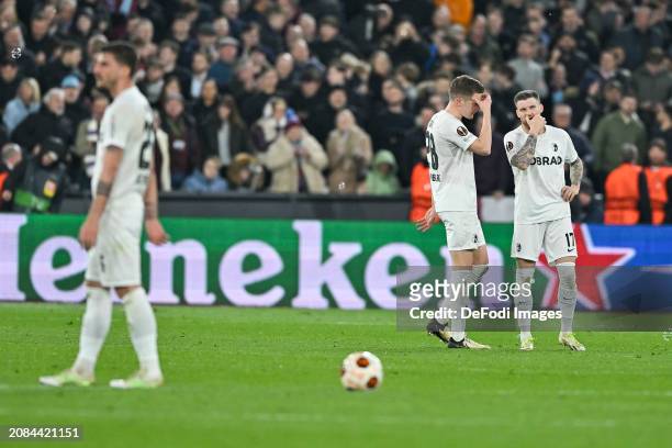Matthias Ginter of SC Freiburg and Lukas Kuebler of SC Freiburg look dejected during the UEFA Europa League 2023/24 round of 16 second leg match...
