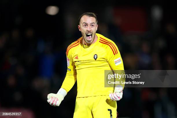 Alex Cairns of Salford City celebrates his side's first goal scored by Luke Garbutt of Salford City during the Sky Bet League Two match between...