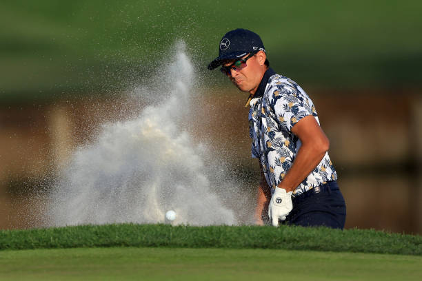 Rickie Fowler of the United States plays a shot from a bunker on the 17th hole during the first round of THE PLAYERS Championship on the Stadium...