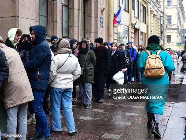 People queue outside a polling station during Russia's presidential election in Saint Petersburg on March 17, 2024. Russian opposition has called on...