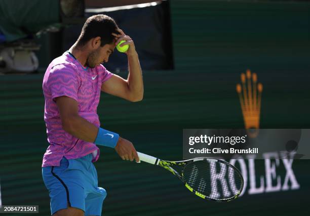 Carlos Alcaraz of Spain is stung by a swam of bees that invaded the court whilst playing against Alexander Zverev of Germany in their Quarterfinal...