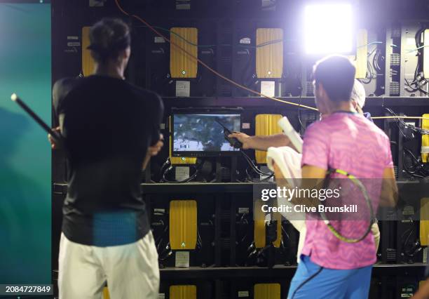 Carlos Alcaraz of Spain and Alexander Zverev of Germany watch on a TV monitor in the players tunnel after running in for cover from a swarm of bees...