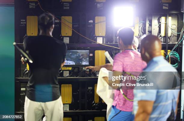 Carlos Alcaraz of Spain and Alexander Zverev of Germany watch on a TV monitor in the players tunnel after running in for cover from a swarm of bees...