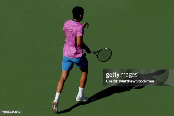 Carlos Alcaraz of Spain flees the court after an invasion of bees suspends his match between Alexander Zverev of Germany during the BNP Paribas Open...
