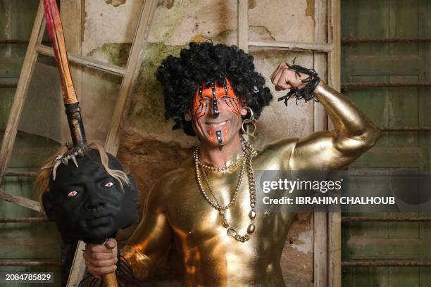 Carnival participant poses for a picture in costume during the Zambo carnival held in the northern Lebanese city of Tripoli on March 17 to mark the...