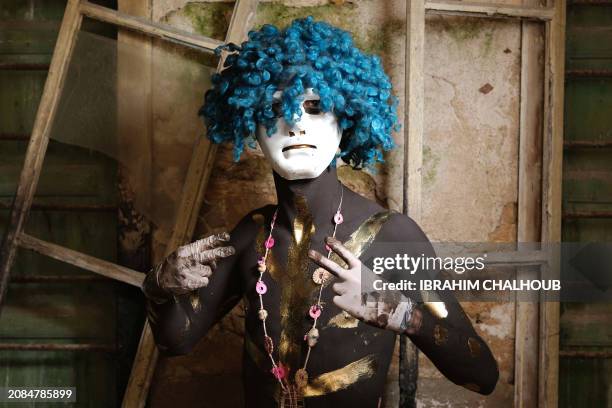 Carnival participant poses for a picture in costume during the Zambo carnival held in the northern Lebanese city of Tripoli on March 17 to mark the...