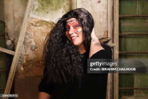 Carnival participant poses for a picture in costume during the Zambo carnival held in the northern Lebanese city of Tripoli on March 17 to mark the...
