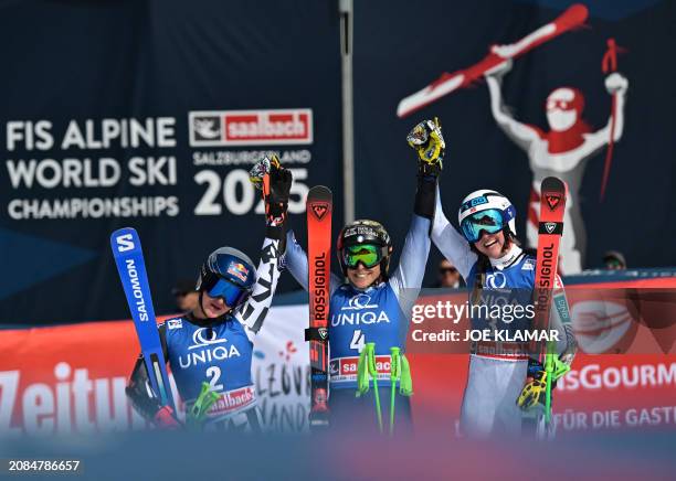 Second placed New Zealand's Alice Robinson, winner Italy's Federica Brignone and third placed Norway's Thea Louise Stjernesund celebrate after the...