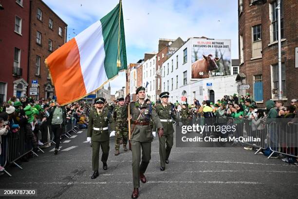 Defence Forces carry flag of the Republic of Ireland as they take part in the St. Patrick's Day parade on March 17, 2024 in Dublin, Ireland. This...