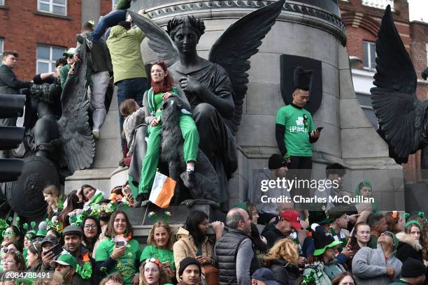 People watch the St. Patrick's Day parade on March 17, 2024 in Dublin, Ireland. This year's theme of the parade is Spréach, the Irish word for Spark,...