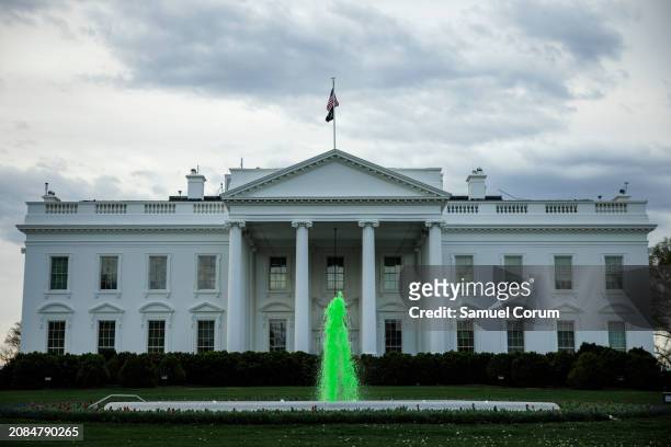The fountain on the North Lawn of the White House is dyed green for Saint Patrick's Day on March 17, 2024 in Washington, DC. The President is...