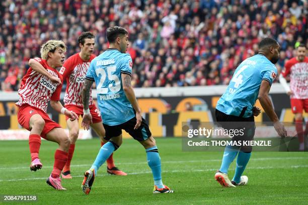 Freiburg's Japanese forward Ritsu Doan scores the 1-1 goal during the German first division Bundesliga football match SC Freiburg v Bayer 04...