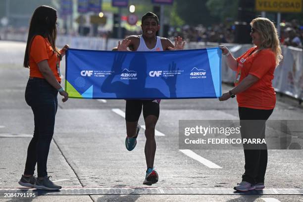 Argentinean runner David Rodriguez crosses the finish line to finish first in the 42 km race of the 8th edition of the Development Bank of Latin...