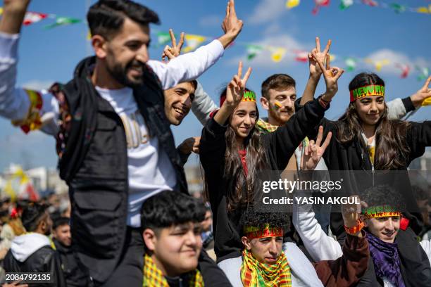 Supporters of the Pro-Kurdish Peoples' Equality and Democracy Party take part in the Kurdish celebration of Nowruz , the New Year of the Persian...