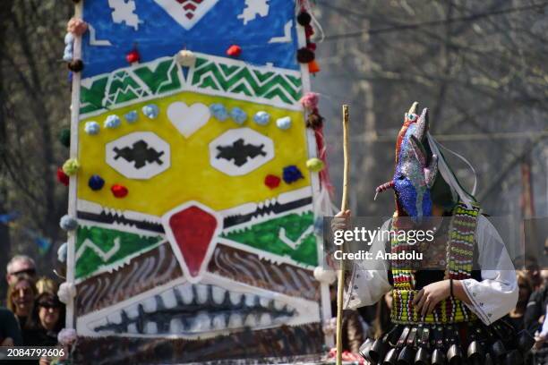 Participants dressed in colorful hand-made costumes and masks attend Mask Festival 'Kukerlandia' in Yambol town of Bulgaria on March 17, 2024....