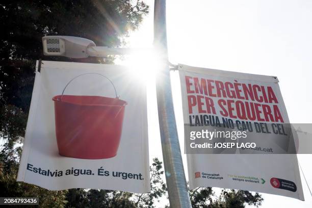 Signs in Catalan reading 'Drought emergency. Water does not fall from the sky. Save water. It is urgent' alert of the prolonged drought episode...