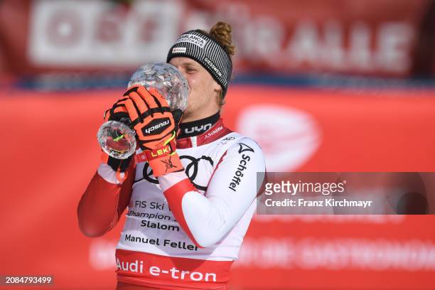 Overall Slalom winner Manuel Feller of Austria celebrates at the Men's Slalom at Audi FIS Alpine Ski World Cup Finals on March 17, 2024 in...