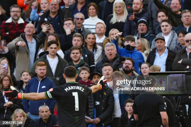 Aston Villa's Argentinian goalkeeper Emiliano Martinez reacts as Australian referee Jarred Gillett checks on VAR the second goal scored by West Ham...