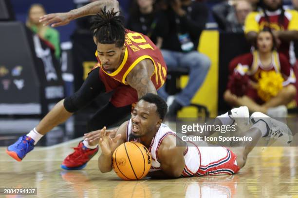 Houston Cougars guard L.J. Cryer and Iowa State Cyclones guard Keshon Gilbert hit the floor for a loose ball in the first half of the Big 12...