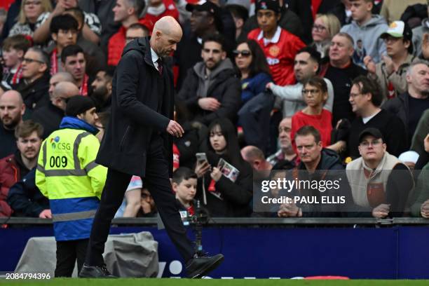 Manchester United's Dutch manager Erik ten Hag walks off at half-time in the English FA Cup Quarter Final football match between Manchester United...