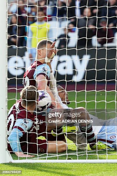 West Ham United's Czech midfielder Tomas Soucek next to West Ham United's English striker Jarrod Bowen scores his team second goal that will be...