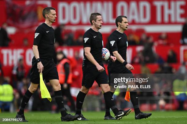 Assistant referee Timothy Wood , English referee John Brooks and assistant referee Lee Betts leave at half-time in the English FA Cup Quarter Final...