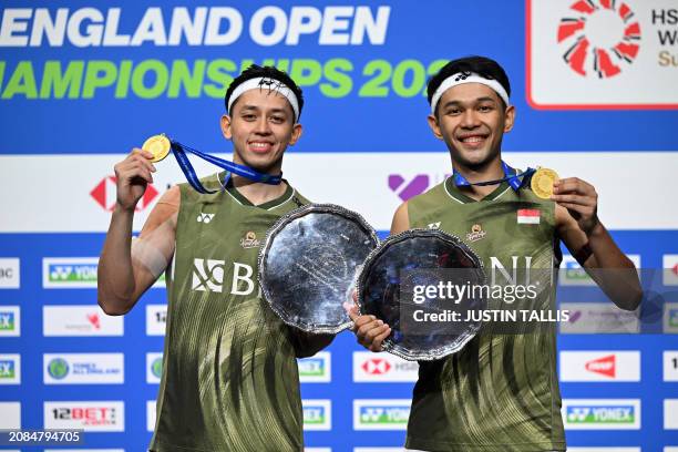 Indonesia's Fajar Alfian and Indonesia's Muhammad Rian Ardianto pose with their medals and trophies after victory over Malaysia's Aaron Chia and...