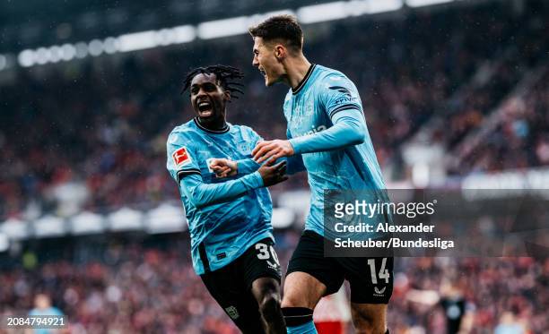 Patrik Schick of Leverkusen celebrates his side's third goal with Jeremie Frimpong of Leverkusen during the Bundesliga match between Sport-Club...