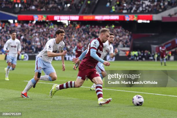 Jarrod Bowen of West Ham United on the attack watched by Pau Torres of Aston Villa during the Premier League match between West Ham United and Aston...