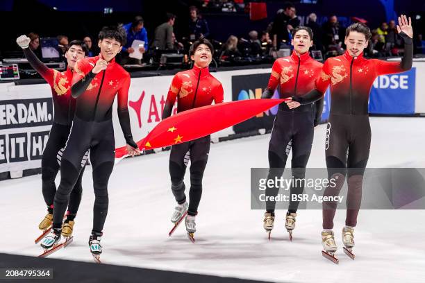 Xiaojun Lin of China, Shaoang Liu of China, Shaolin Liu of China, Long Sun of China celebrating gold medal and holding flag after competing in the...