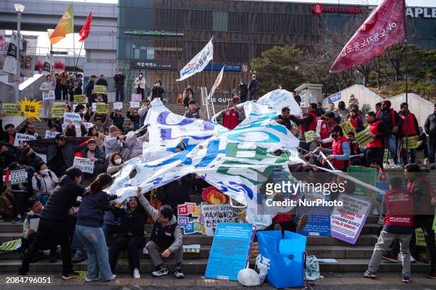 Migrant workers are performing a banner-tearing demonstration to protest against racial discrimination at Seoul Station Square in Seoul, South Korea,...
