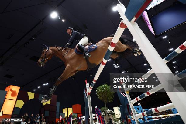 Britain Ben Maiher riding Enjeu De Grisen competes in the "Grand Prix Hermes CSI 5" International Jumping Competition at the Grand Palais Ephemere in...