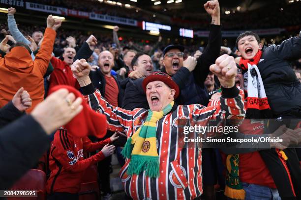 Manchester United fans celebrate after the Emirates FA Cup Quarter Final match between Manchester United and Liverpool at Old Trafford on March 17,...