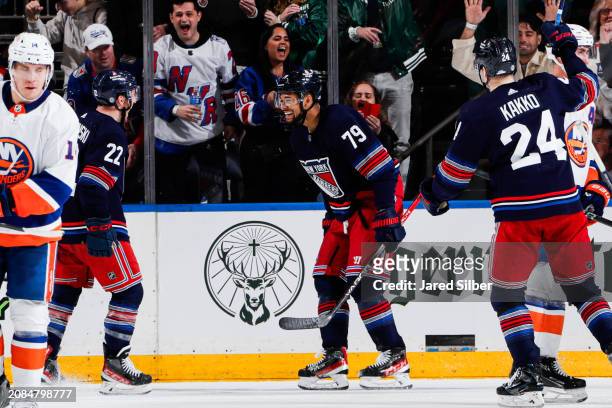 Jonny Brodzinski of the New York Rangers celebrates with teammates after scoring a goal in the second period against the New York Islanders at...