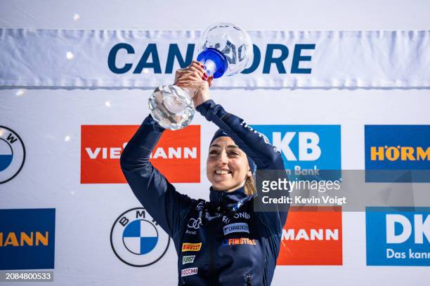 Lisa Vittozzi of Italy with the trophy during the award ceremony for the total world cup score after the Women 12.5 km Mass Start at the BMW IBU...