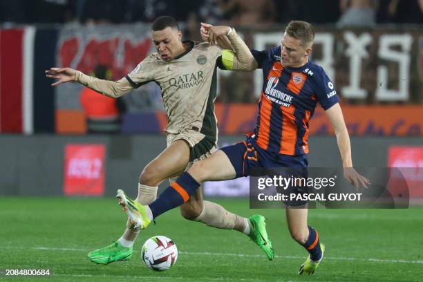 Paris Saint-Germain's French forward Kylian Mbappe fights for the ball with Montpellier's Swiss defender Becir Omeragic during the French L1 football...