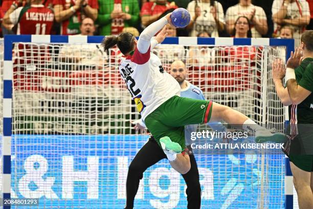 Portugal's Luis Frade and Hungary's goalkeeper Laszlo Bartucz vie during the men's Handball Olympic qualifying match between Hungary and Portugal in...