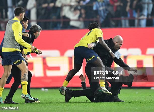 Players of Fenerbahce get a fight with a supporter, who enters to the pitch, after the Turkish Super Lig week 30 football match between Trabzonspor...